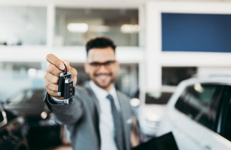 Person holding up a car key