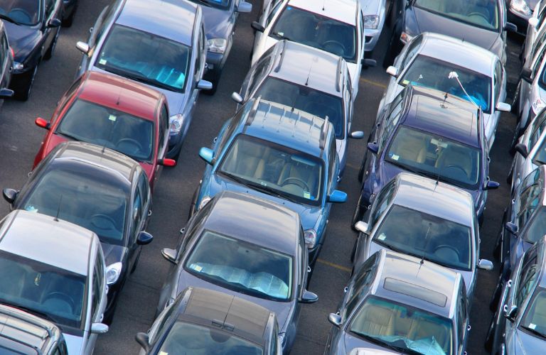 Used vehicles at a dealership's parking lot