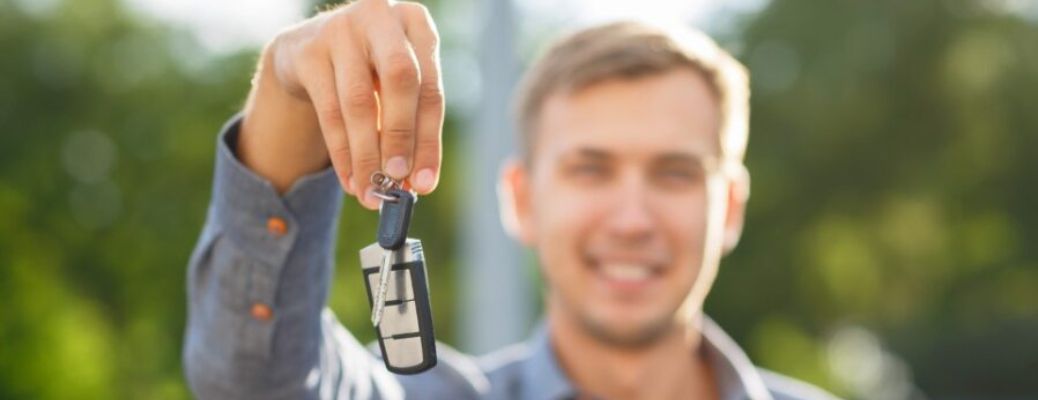 man holding a car key