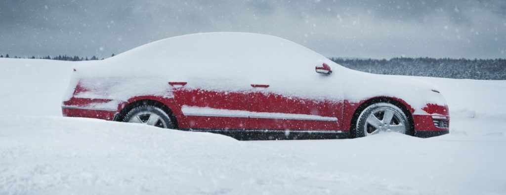 A red car with snow piled on top