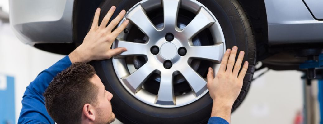 Technician adjusting tire