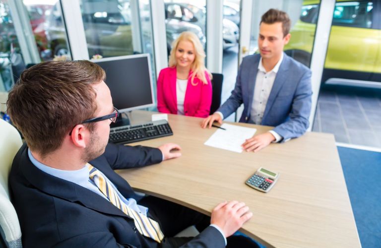 People talking to each other at a dealership
