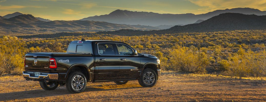 A right profile photo of the 2019 Ram 1500 parked in front of mountains