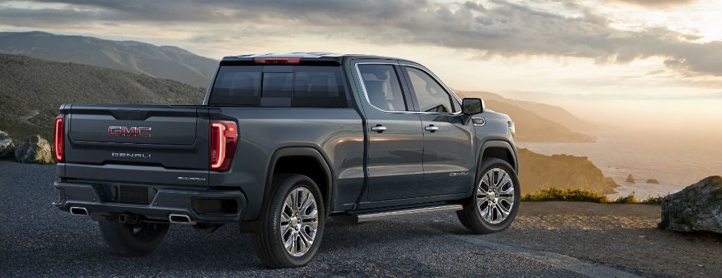 A rear right quarter image of the 2019 GMC Sierra looking over a bluff.