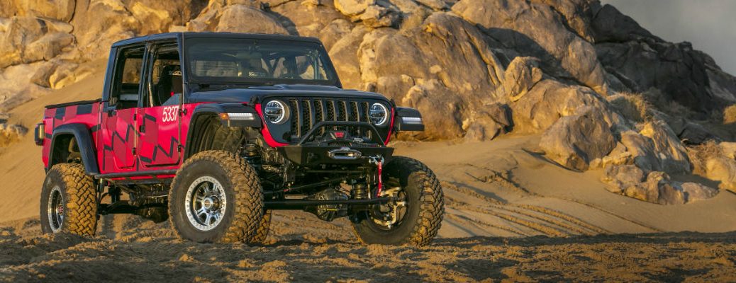 A front right quarter photo of the Jeep Gladiator parked in the desert.