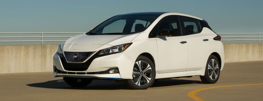A left profile photo of the 2020 Nissan LEAF parked on the road.
