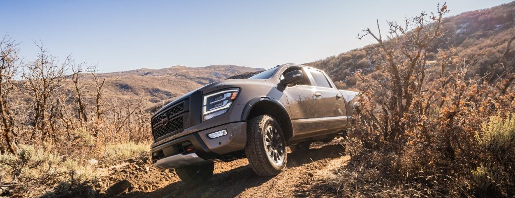 A photo of the 2021 Nissan Titan coming over the hill.