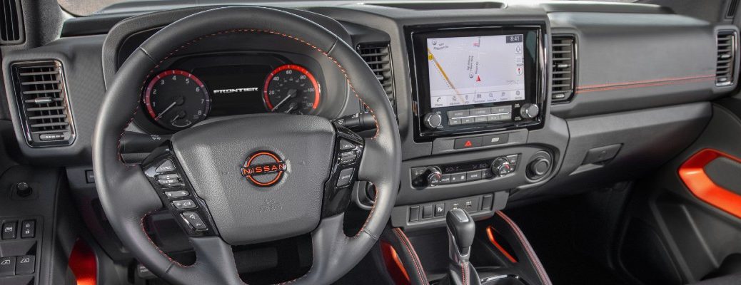 The driver's cockpit and dashboard in the 2022 Nissan Frontier.