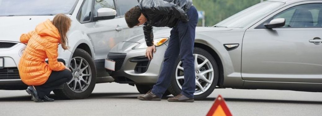 Two people talking of the collision that happened with their respective cars