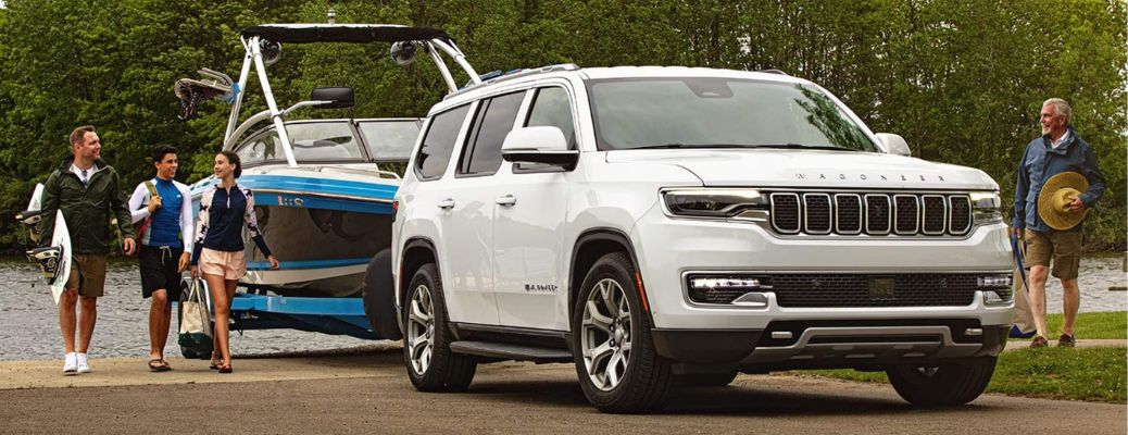 2022 Jeep Wagoneer towing a motor boat out of the lake.