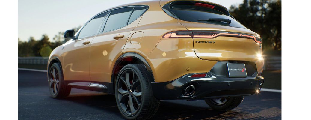 One yellow color 2023 Dodge Hornet is running on the road.