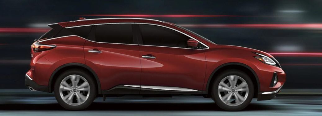 One red color 2023 Nissan Murano is running on the road.
