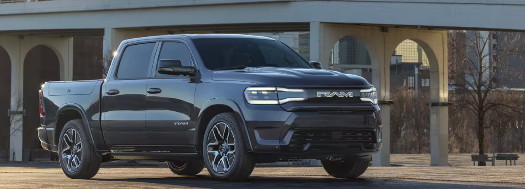 2025 Ram 1500 REV parked in front of a building