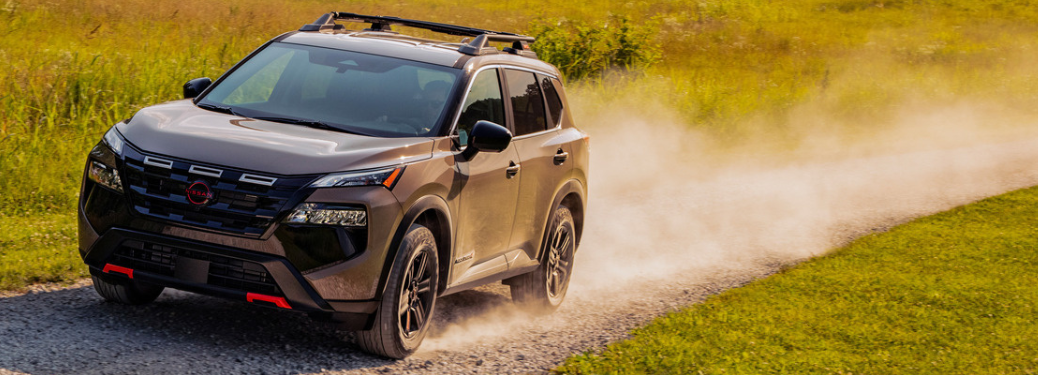 Side view of the 2025 Nissan Rogue Rock Creek edition on rough terrain