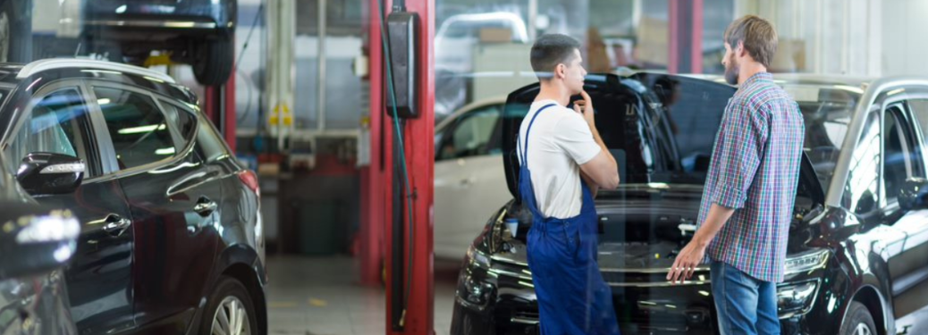 Mechanic talking to a customer at a service station