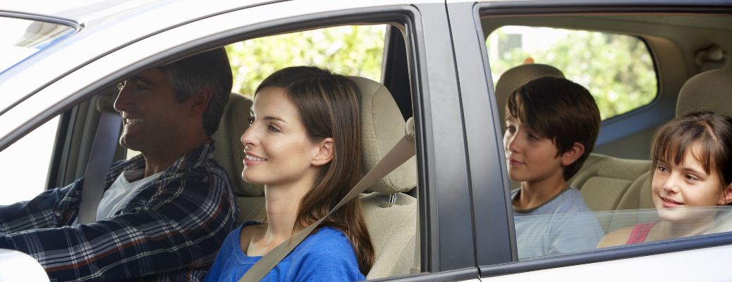 Family of four sitting inside a car
