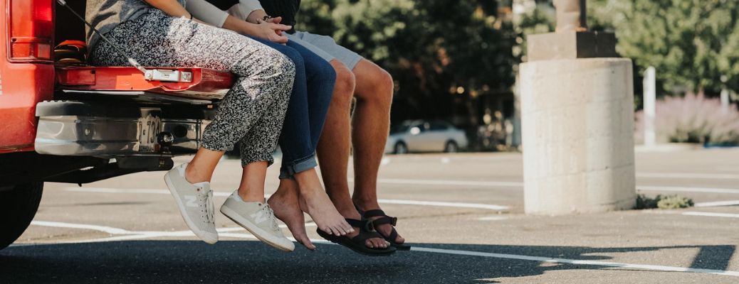 friends sitting on the tailgate