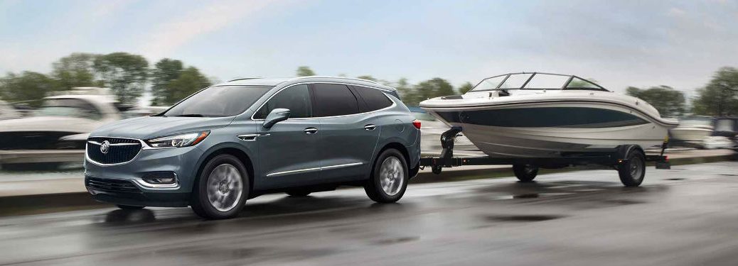 Exterior side view of 2018 Buick Enclave towing a speed boat