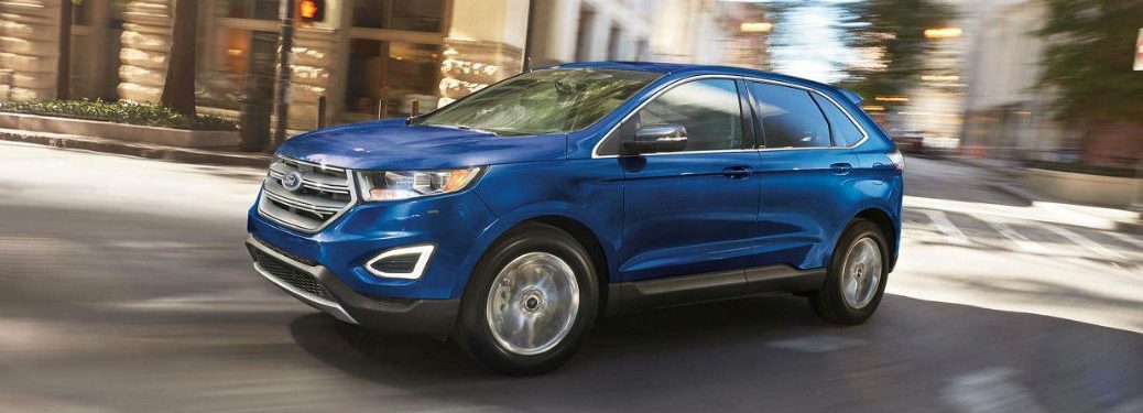 Driver side exterior view of a blue 2018 Ford Edge