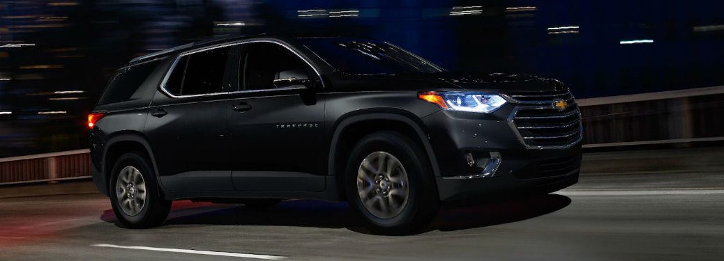 Passenger side exterior view of a black 2018 Chevy Traverse