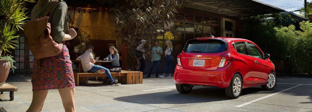 Rear passenger side exterior view of a red 2019 Chevy Spark
