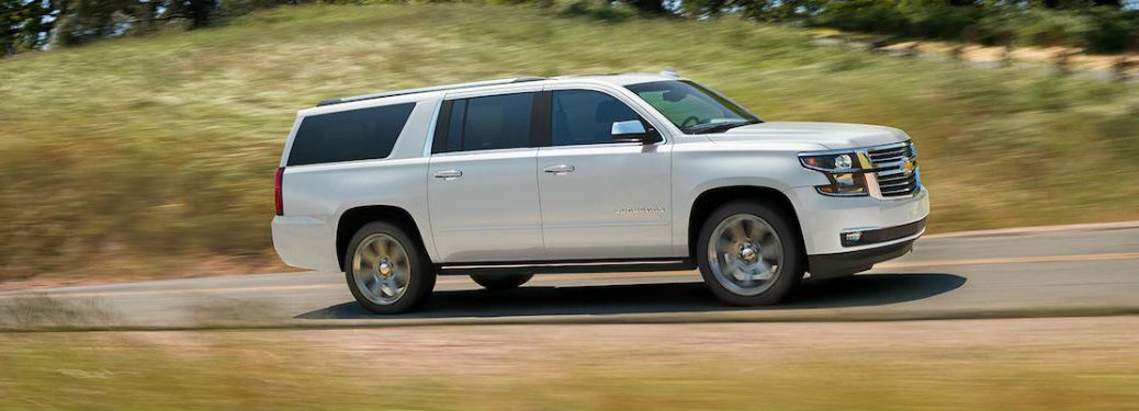 Passenger side exterior view of a white 2019 Chevy Suburban