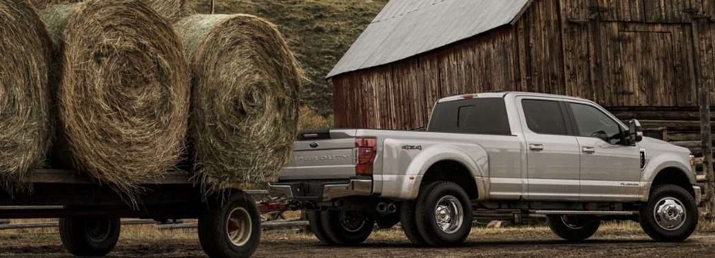 2020 Ford F-350 LARIAT towing hay on trailer