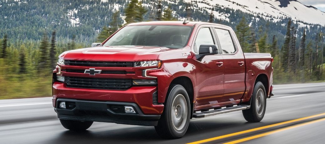 Red 2020 Chevy Silverado 1500 from front driver side angle on road in front of mountain