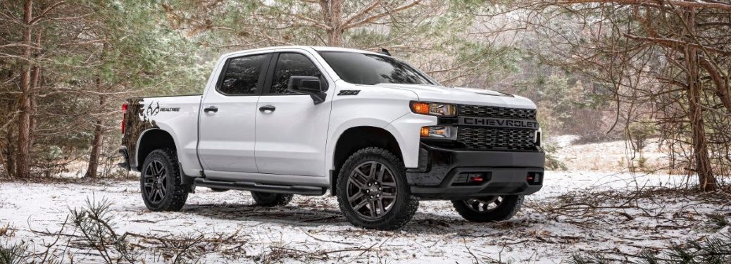 camo chevy silverado in the woods