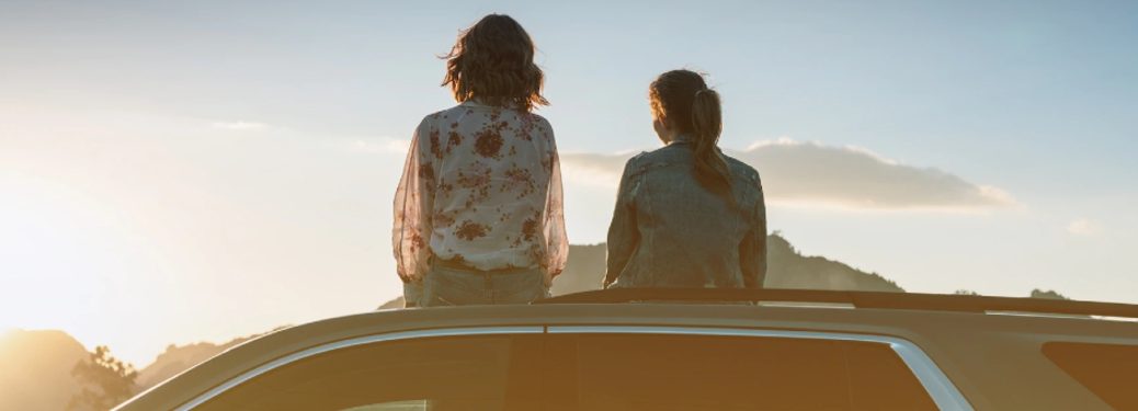 people sitting on top of a vehicle