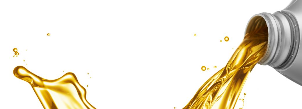 Oil splashes from a bottle and across a white void