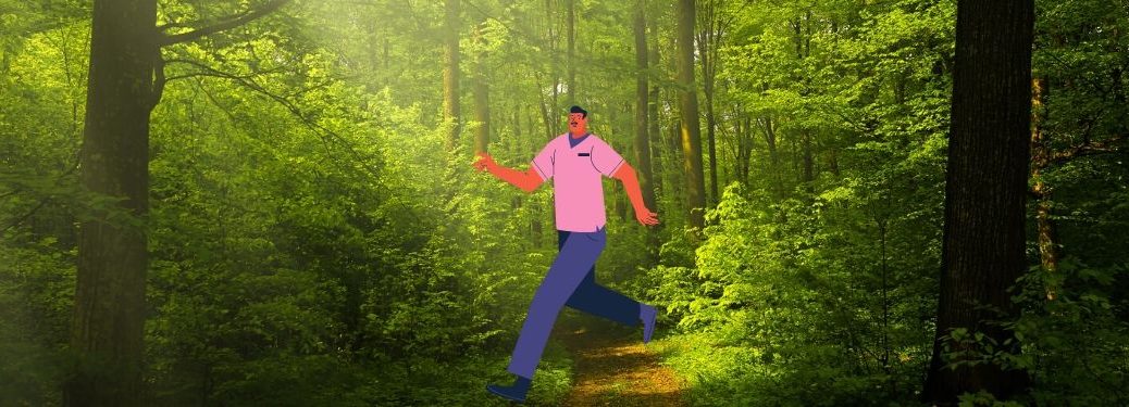 A man happily struts through the forest