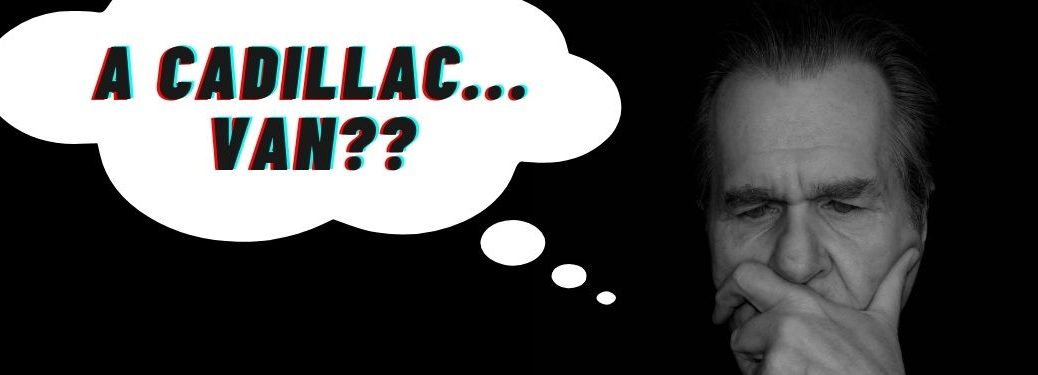 A man sits in a dark room and intently ponders the existence of a Cadillac branded van