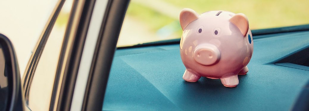 Piggy bank sitting on dashboard