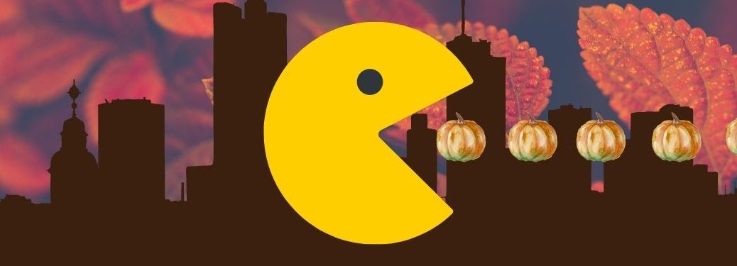 Pac-Man eats a line of oil-painted pumpkins with a city and autumn leaf backdrop