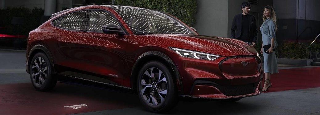 Red 2021 Ford Mustang Mach-E outside some fancy club