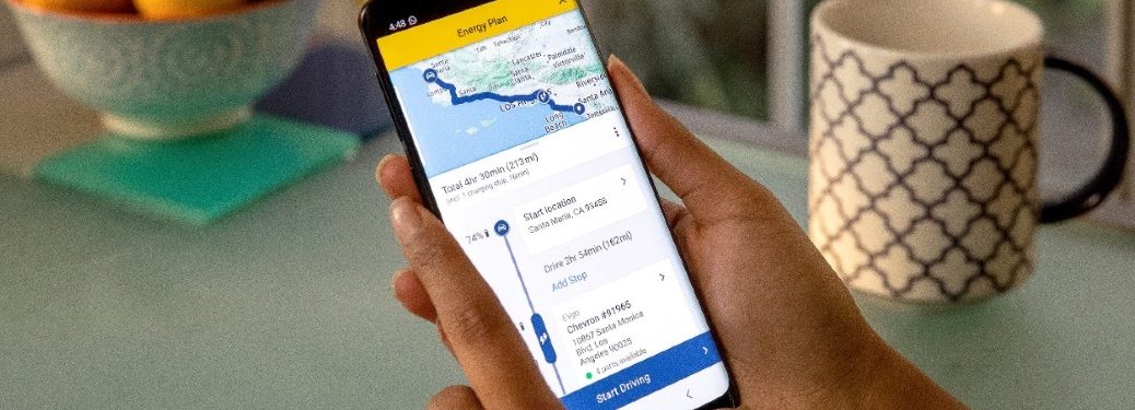 Hand holds a phone with the Energy Assist app open on the screen
