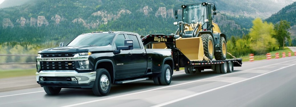2021 Chevrolet HD truck pulling heavy machinery