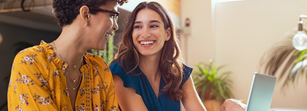 Two people enjoy a computer
