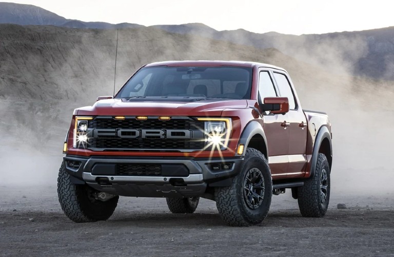 Front driver angle of a red 2021 Ford F-150 Raptor