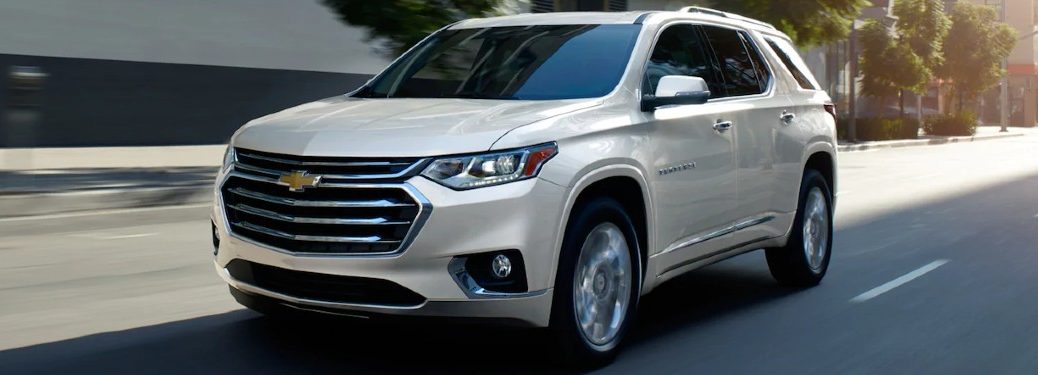 Front driver angle of a white 2021 Chevrolet Traverse driving on a road
