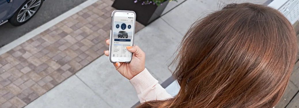 Woman using the FordPass mobile app