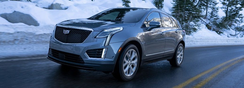 Front driver angle of a grey 2021 Cadillac XT5 driving in winter