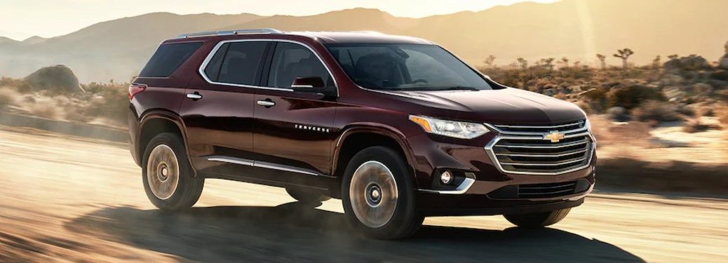 Front passenger angle of a dark red 2021 Chevrolet Traverse