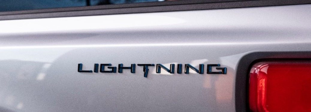 Close up of the Lightning logo on a white Ford F-150