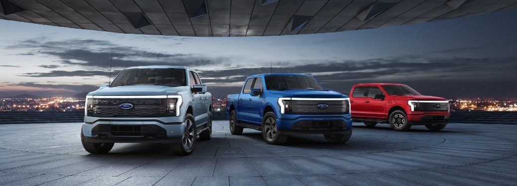 Three 2022 Ford F-150 Lightning vehicles parked next to each other