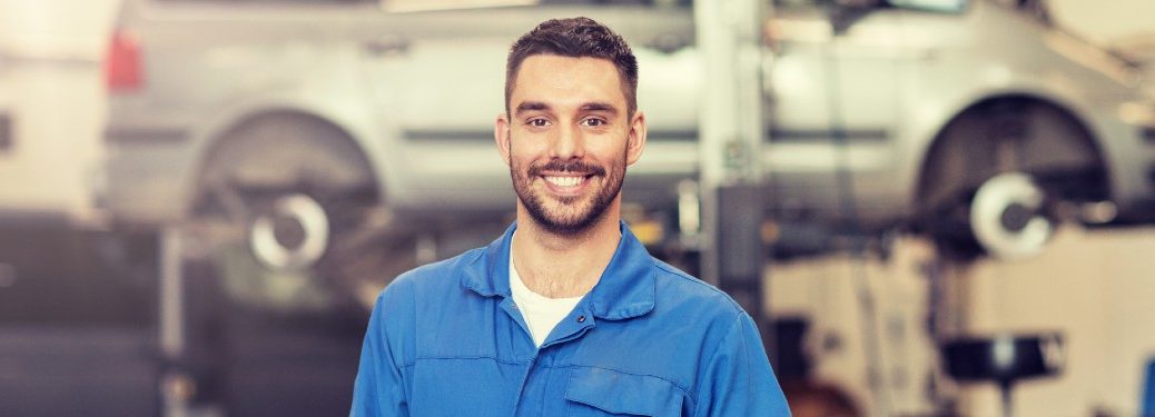 Happy mechanic in a vehicle shop
