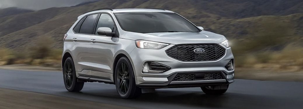 A silver 2021 Ford Edge on the road.