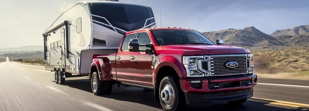 A red 2022 Ford F-350 towing a trailer.