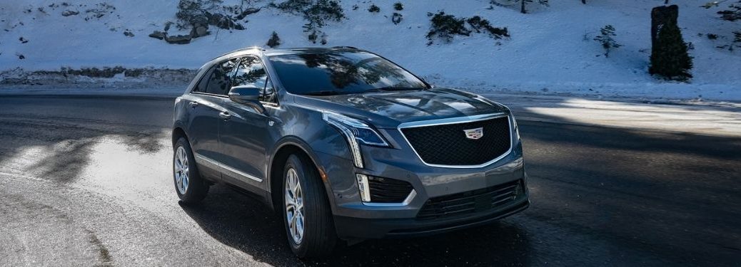 A 2021 Cadillac XT5 driving on mountain road.